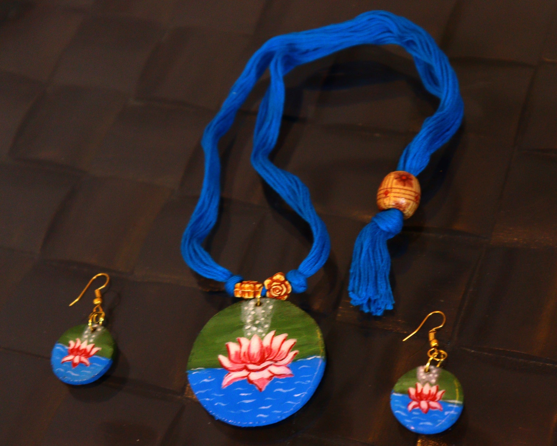 Jewelry set with necklace and earrings on a textured surface