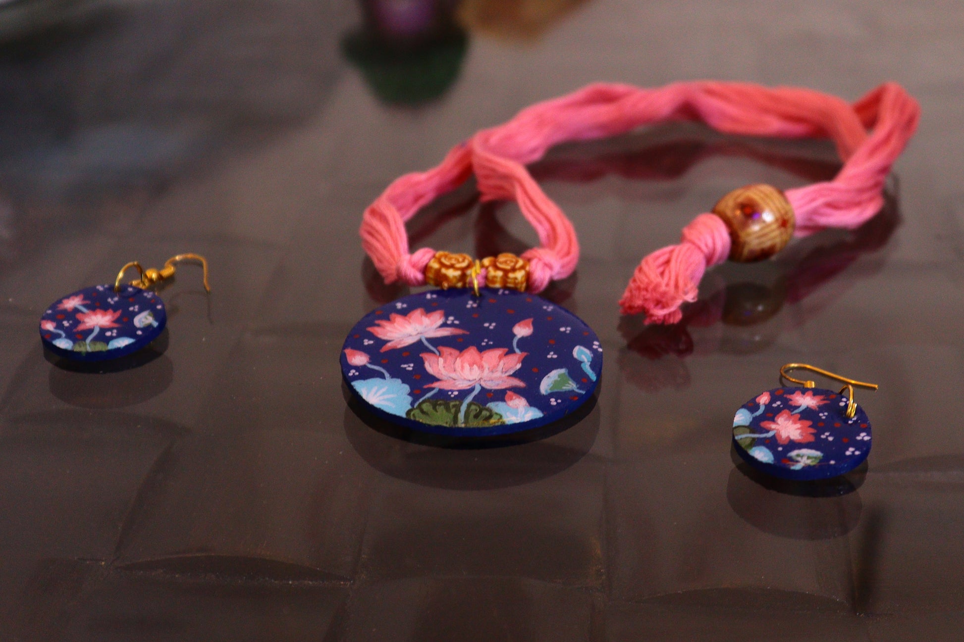 Set of colorful jewelry on a reflective surface