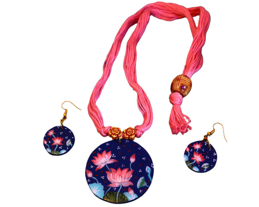 Necklace with pink cord and matching earrings on a dark textured background