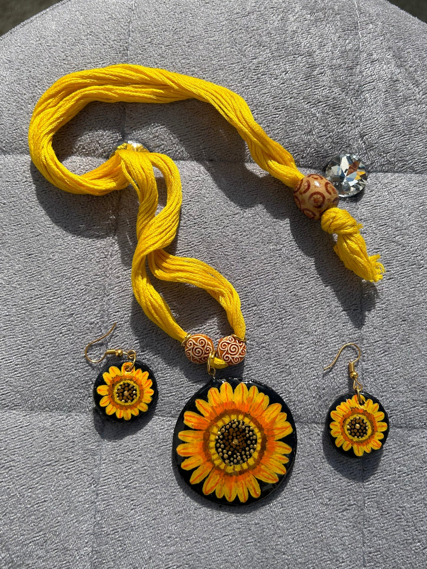 Yellow thread with decorative elements on a gray surface