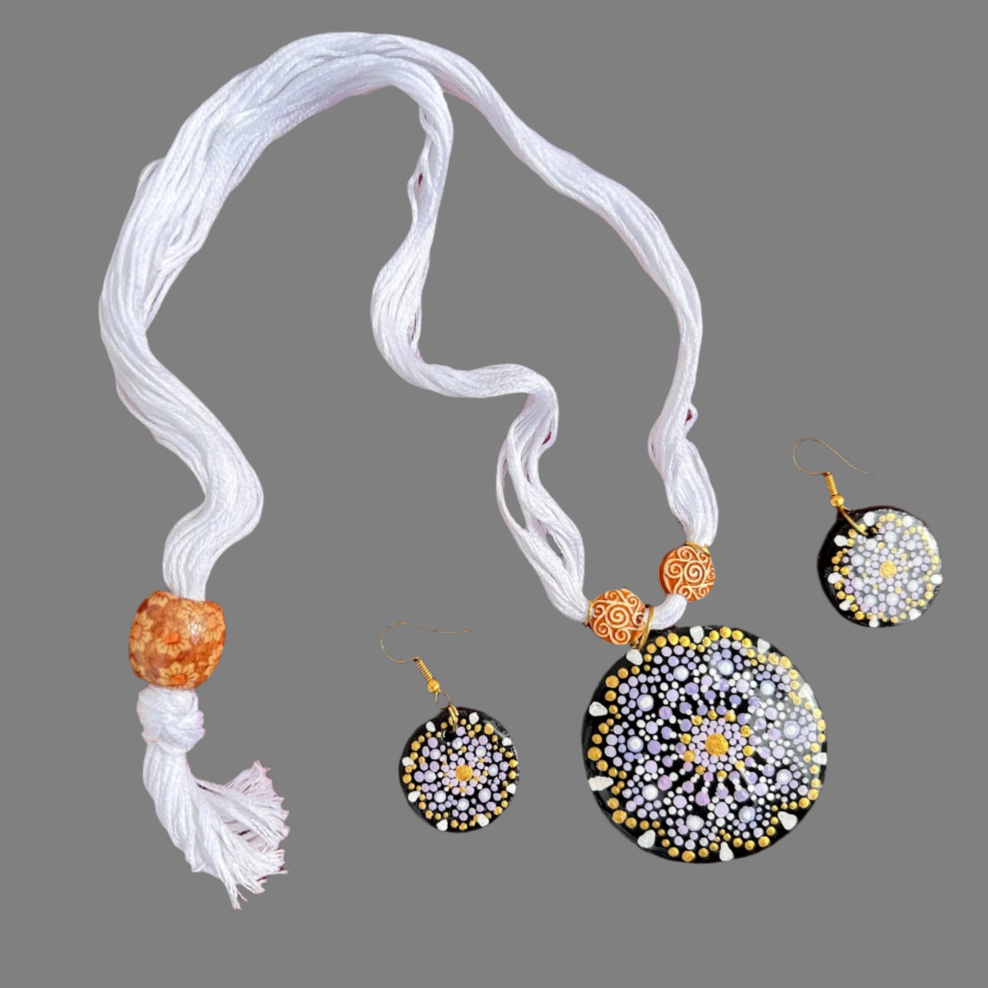 Jewelry set with necklace and earrings on a red fabric background