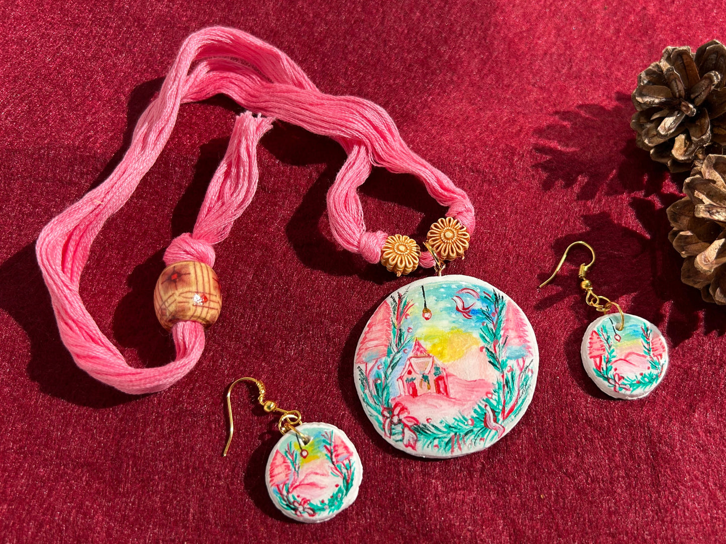 Jewelry set with pink ribbon, necklaces, and earrings on a red background
