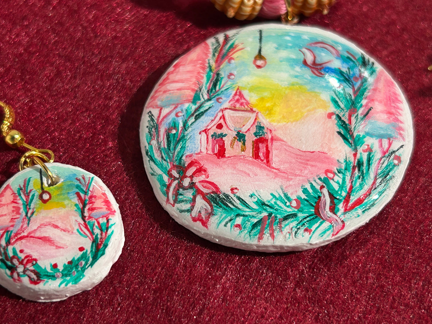 Hand-painted stone with a scenic design on a red background