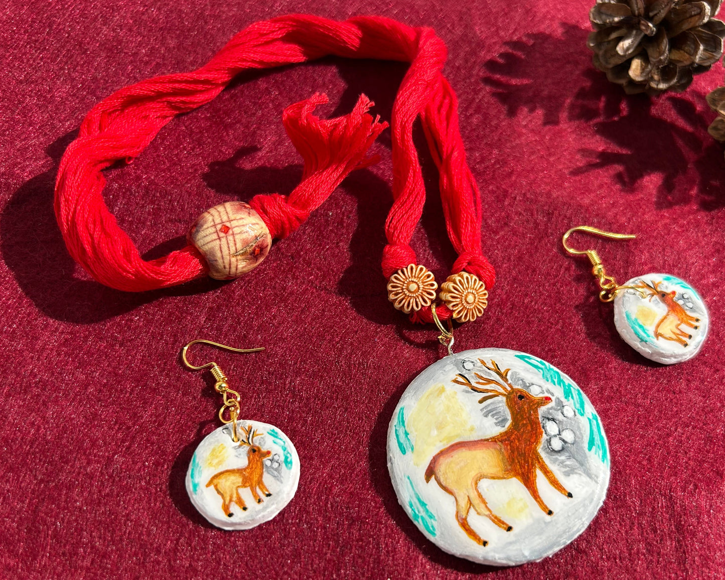 Jewelry set with earrings and a necklace on a red background