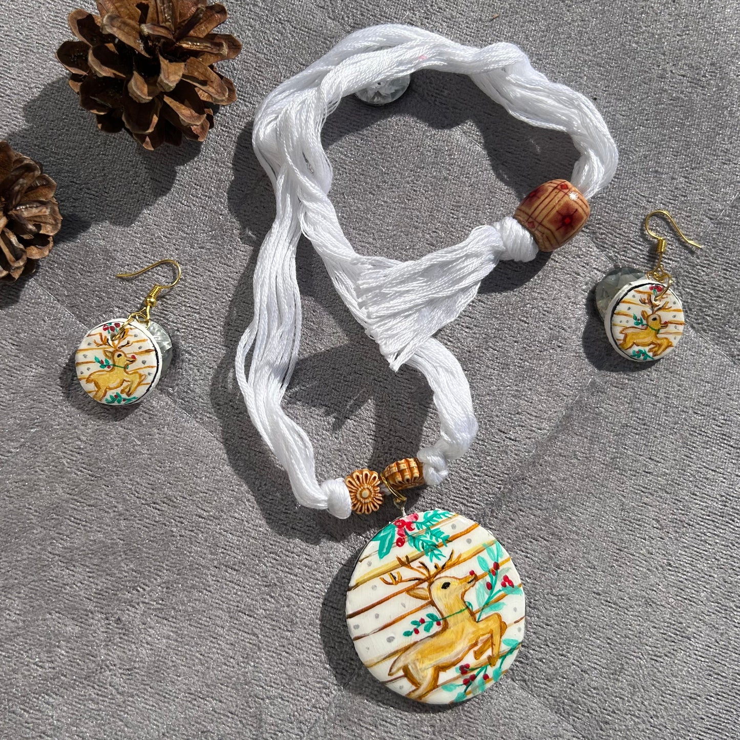 Decorative necklace with matching earrings on a gray surface