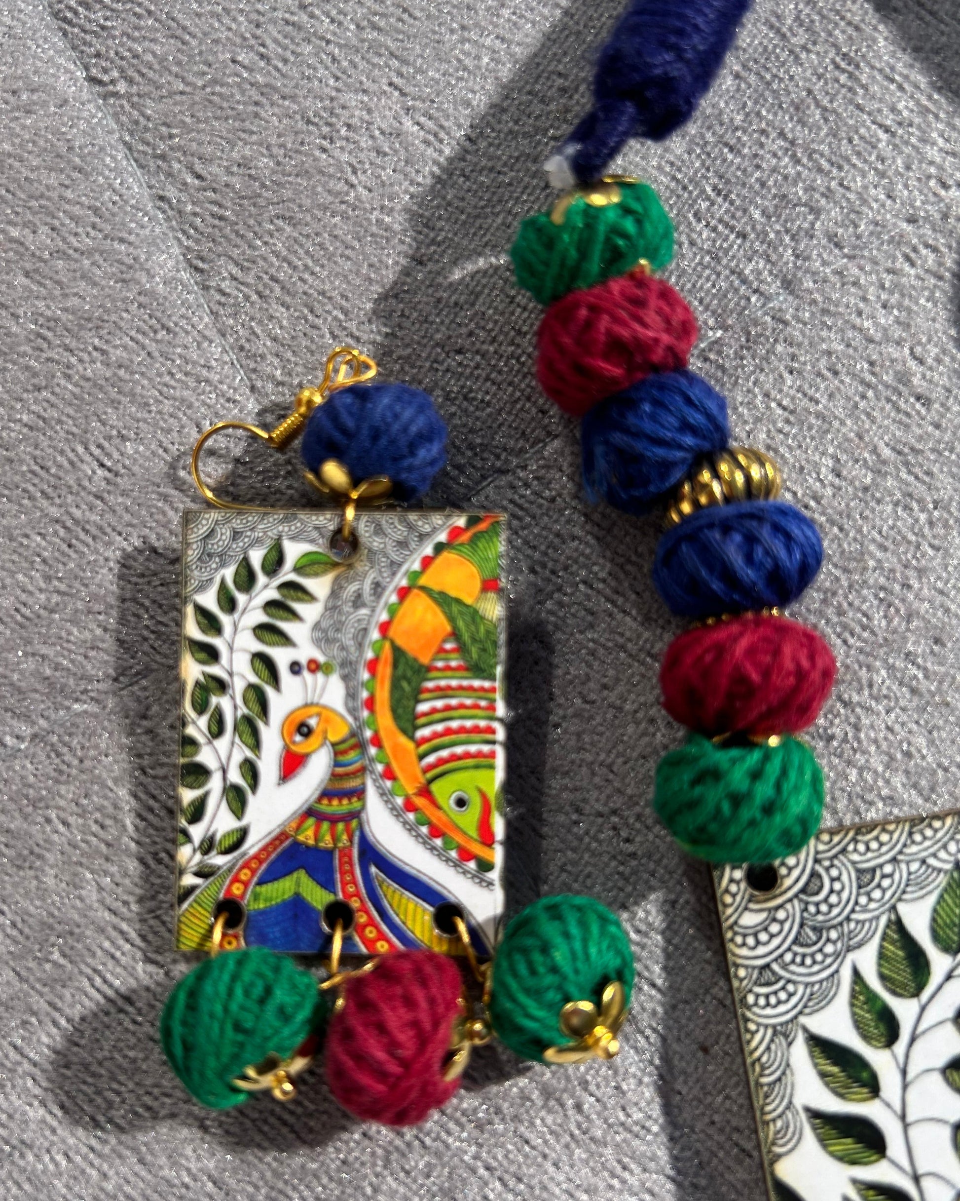 Colorful Earrings with decorative beads on a textured surface