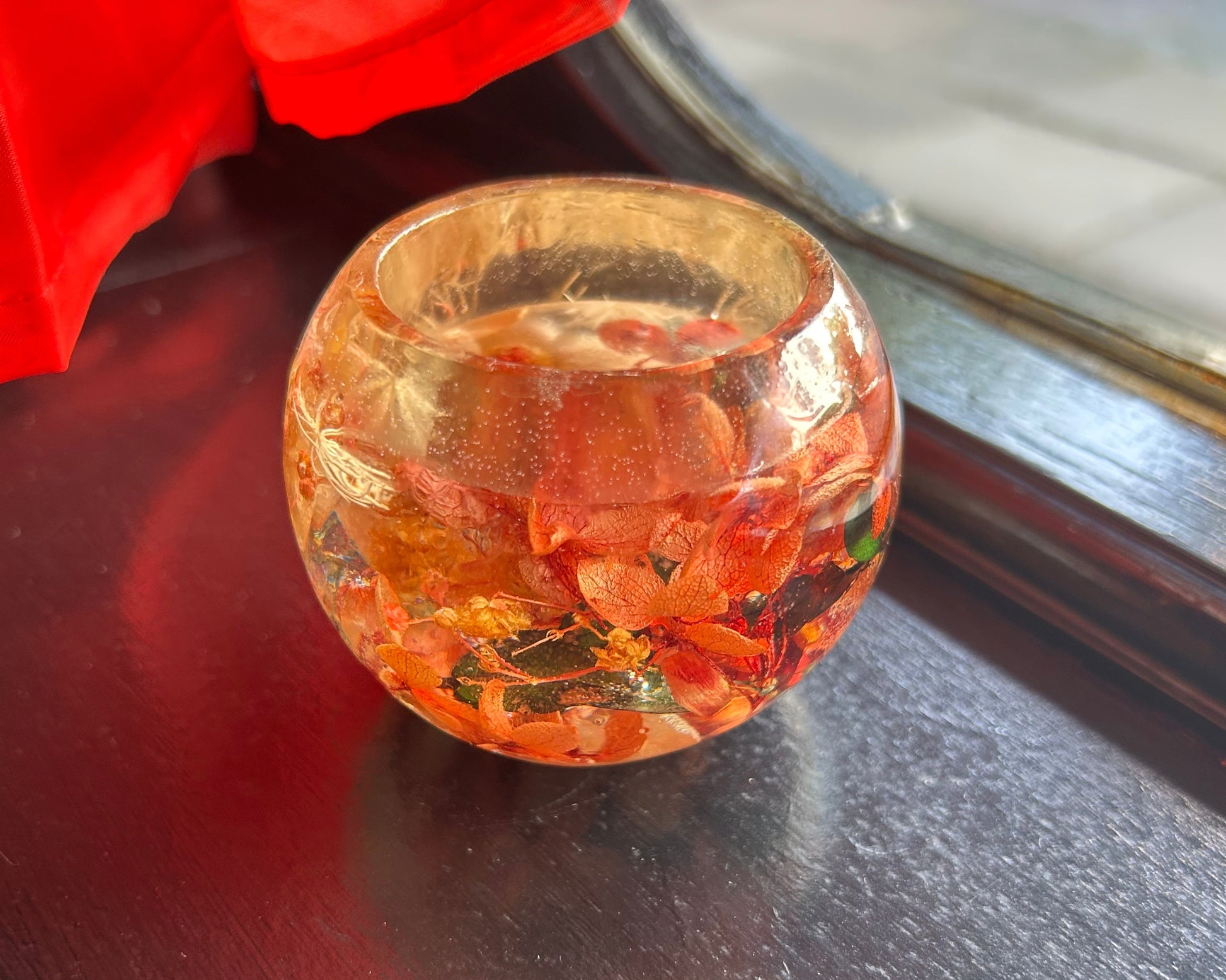 Decorative glass bowl with marbles on a dark surface