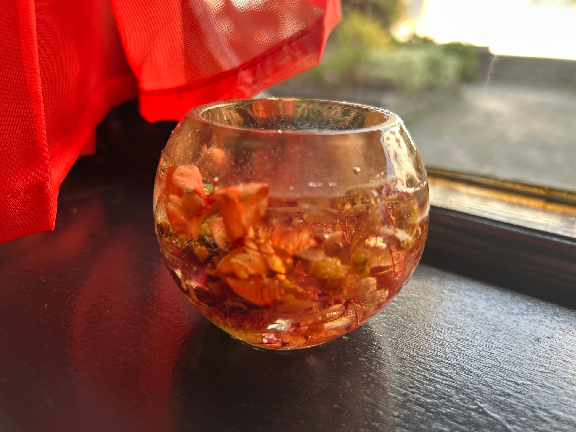 Resin with dried flowers on a reflective surface