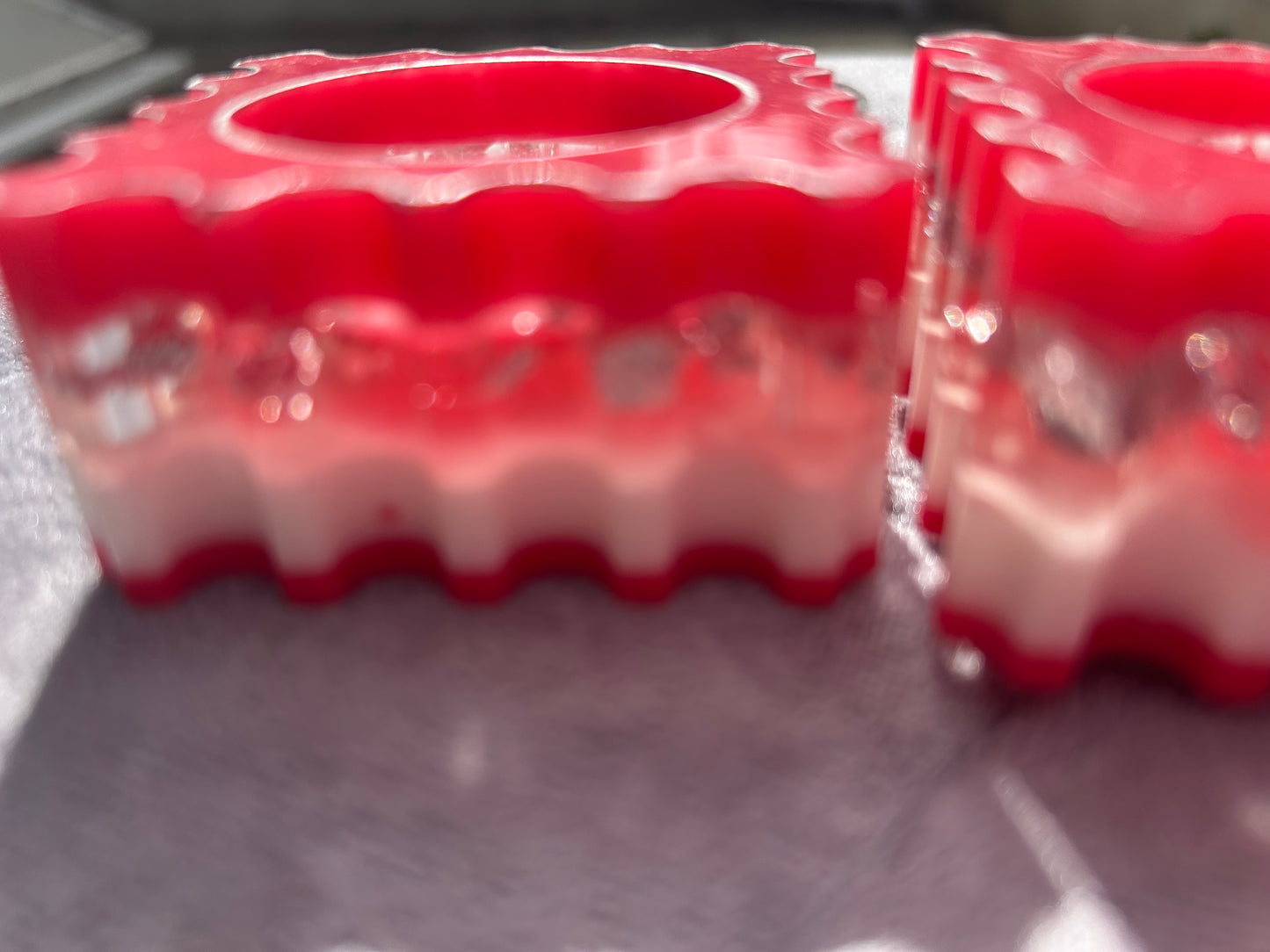 Two red rubber blocks with a textured surface on a metallic surface.