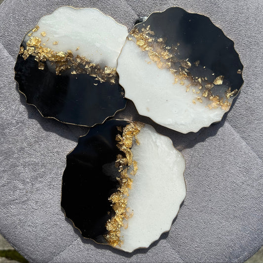 Black and white stone with gold inclusions on a gray surface