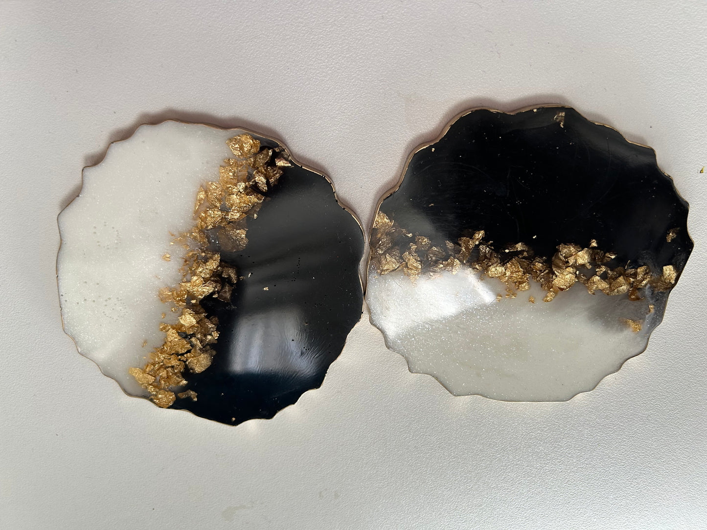 Two agate slices with gold inclusions on a gray background