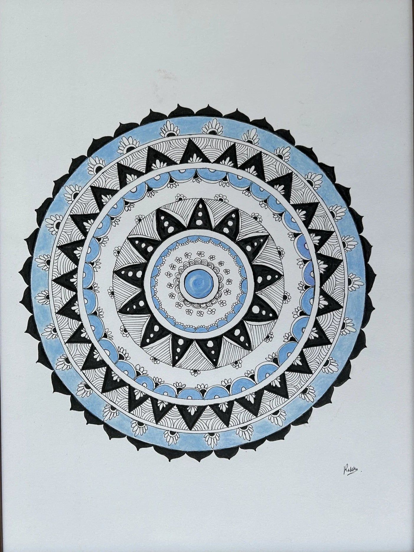 Framed mandala art with concentric circles on a white background